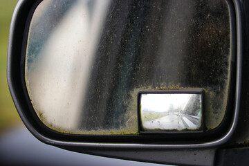 veiw through a grimy old car mirror