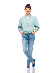 Fototapeta premium people, ethnicity and portrait concept - happy asian young woman in cotton shirt and jeans over white background