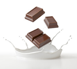 The piece of dark chocolate falling in a milk splash