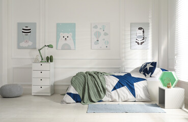 Bed with stylish linens in children's room