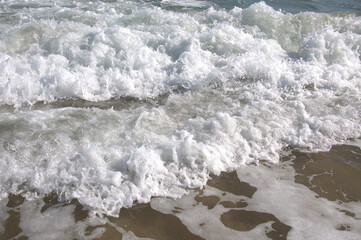 Tide coming in along the beach.