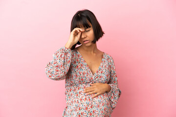 Young pregnant woman over isolated pink background with tired and sick expression