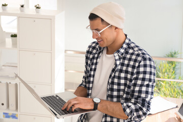 Fototapeta na wymiar Freelancer working on laptop in home office