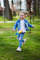 Little girl with a pinwheel in the park