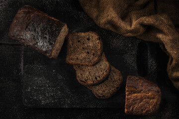 Fresh cutted bread baked homemade artisan sourdough rye on table close-up. Fresh bread on the kitchen table. Traditional bakery concept. Rustic style