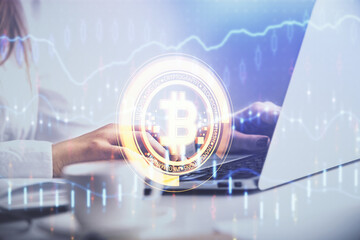 Double exposure of woman hands typing on computer and crypto market theme hologram drawing....