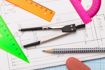 Various tools for sketching on paper with blueprints, top view