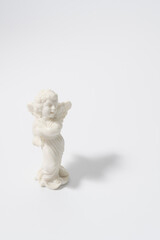 Figurine of an angel made of plastic on a white background
