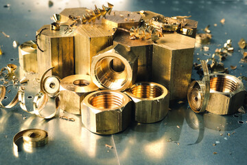 Golden metal parts turned on a lathe in a heavy industry plant. Metalworking of products on cnc machines. 
