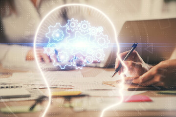 Multi exposure of woman hands working on computer and brain hologram drawing. Ai concept.