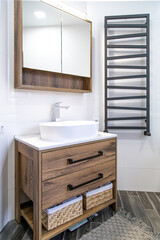 Modern bathroom interior with wooden furniture close up.