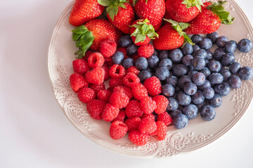 fresh ripe juicy wild berries raspberries and blueberries
