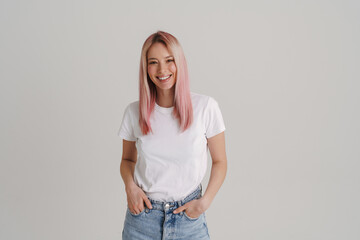 Young woman with pink hair smiling and looking at camera