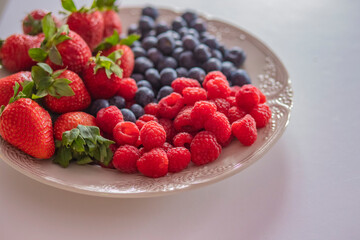 fresh ripe juicy wild berries raspberries and blueberries
