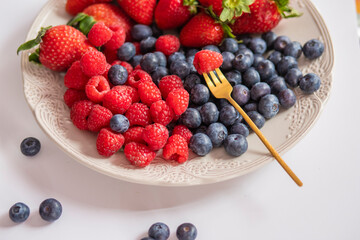 fresh ripe juicy wild berries raspberries and blueberries
