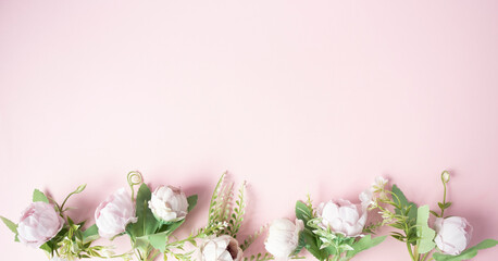 Flowers on a pink background arranged in a line from the bottom.
