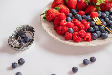 fresh ripe juicy wild berries raspberries and blueberries
