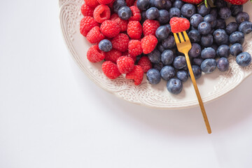 fresh ripe juicy wild berries raspberries and blueberries
