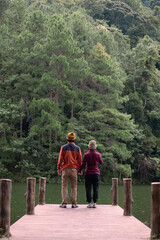 Happy couple traveler standing and looking Nature view, tourists in sweater traveling at Pang Oung, Mae Hong Son, Thailand. Together, travel, trip and vacation concept