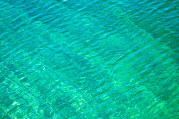 Sea water clear background. Bright turquoise water aqua texture. Vacations summer mood concept