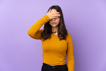 Young mixed race woman isolated on purple background covering eyes by hands. Do not want to see...
