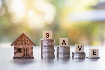 The word "SAVE" is placed on the coin ladder and the model house. Concept of saving house plans. Investing in real estate for saving or investing for a house and paying taxes.