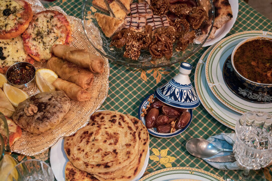 plate of varieties of food and pizza rations and HEALTHY VEGETABLES IN THE BACKGROUND OF OTHER FOOD DISHES