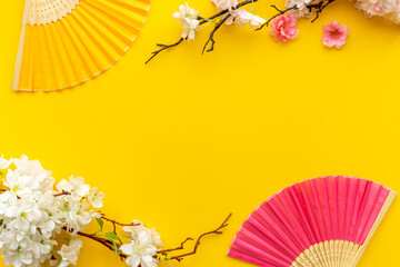 Blossom branches with asian hand fans. Top view