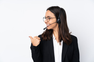 Young telemarketer woman isolated on white background pointing to the side to present a product