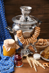 Traditional Russian samovar and treats on wooden table