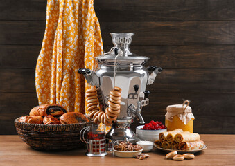 Traditional Russian samovar and treats on wooden table