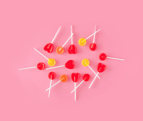 Various lollipops against pink background. Creative colorfool idea.