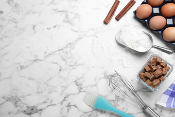 Cooking utensils and ingredients on white marble table, flat lay. Space for text