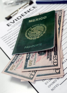 Some fifty-dollar notes in a Mexican passport in a crime lab, concept image