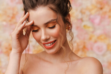 Obraz premium Young smiling woman with long brown curly hair