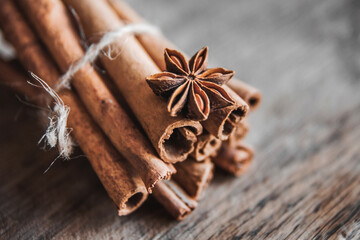 Cinnamon sticks and anise star on a wooden background. Copy, empty space for text