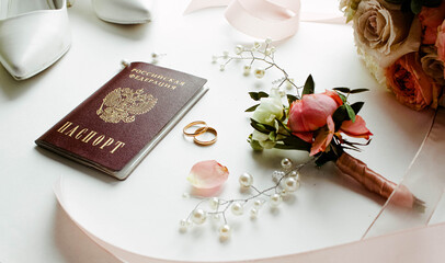 Beautiful  flowers, pearl jewelry and two gold wedding rings on a white background. Marriage concept. Wedding bouquet with passport of the Russian Federation. Isolated  - Powered by Adobe