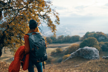 woman hiker backpack in travel mountains autumn lifestyle