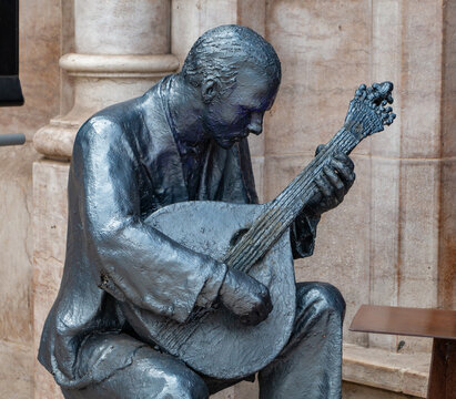 Lisbon, Portugal - June 4, 2016: A picture of a sculpture showing a Portuguese guitar player, representing the Fado music genre, traditional of Portugal.