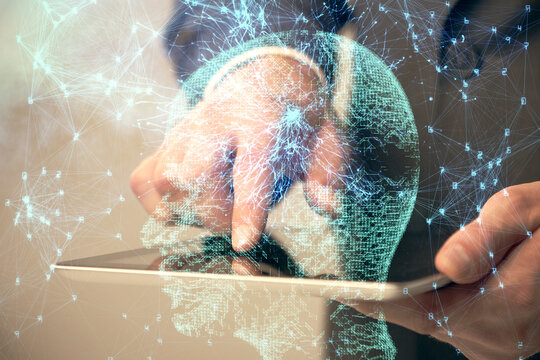 Double exposure of man's hand holding and using a digital device and brain hologram drawing. Data concept.