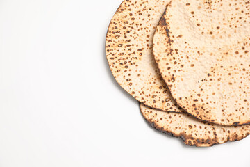 Tasty matzos on white background, top view. Passover (Pesach) celebration