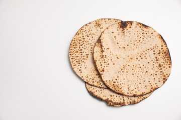 Tasty matzos on white background, top view. Passover (Pesach) celebration