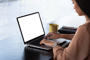 side view of a young Asian businesswoman printing work on a tablet blank white screen at the...