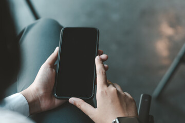 Close-up  Businessman hands sitting at work holding a smartphone.