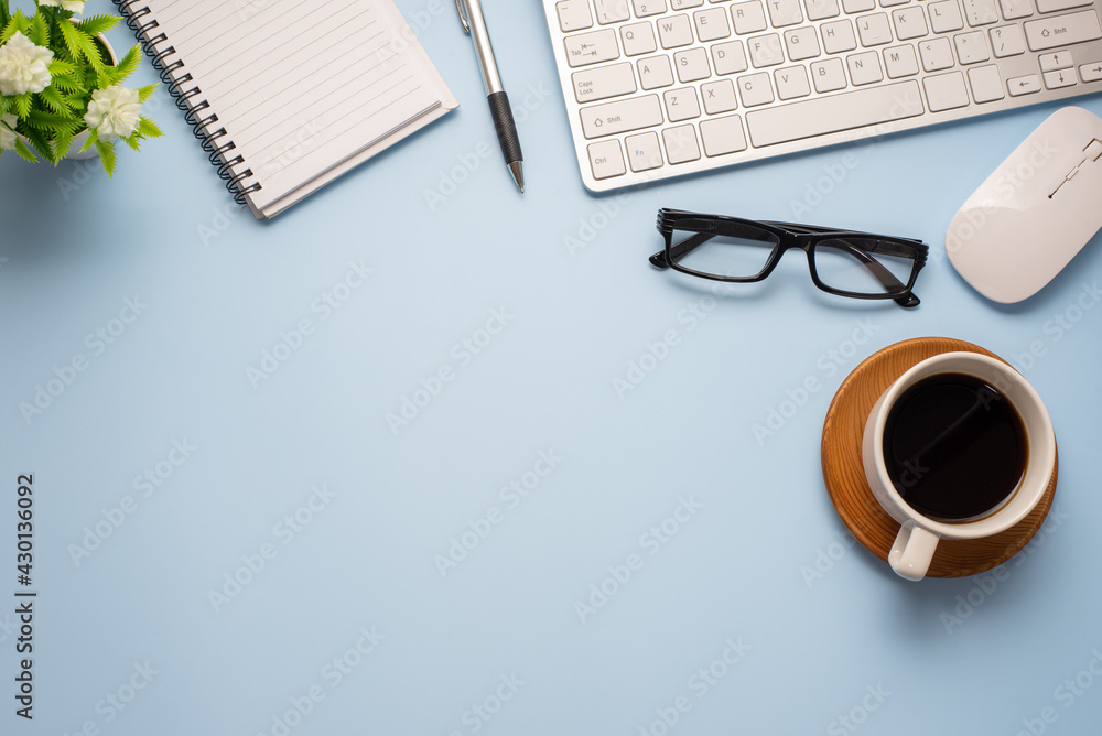 Poster blue desk minimal style with coffee glasses notebook keyboard copy space.