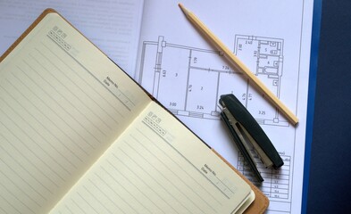 The project of construction, redevelopment of the apartment. A plan on paper. Notepad pencil and...
