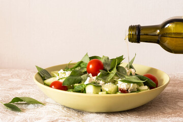 The process of preparing a salad. Salad dressing. Vegetable oil is poured in a trickle into a plate...