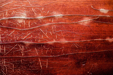 background wooden and varnished surface with scratches and cracks