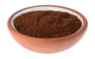 Side view of a small terracotta spice bowl filled with chili powder isolated on a white background.