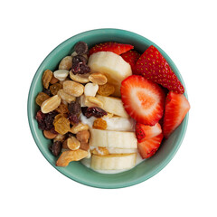 Overhead view of a bowl with plain Greek yogurt candy trail mix bananas and strawberries isolated on a white background.